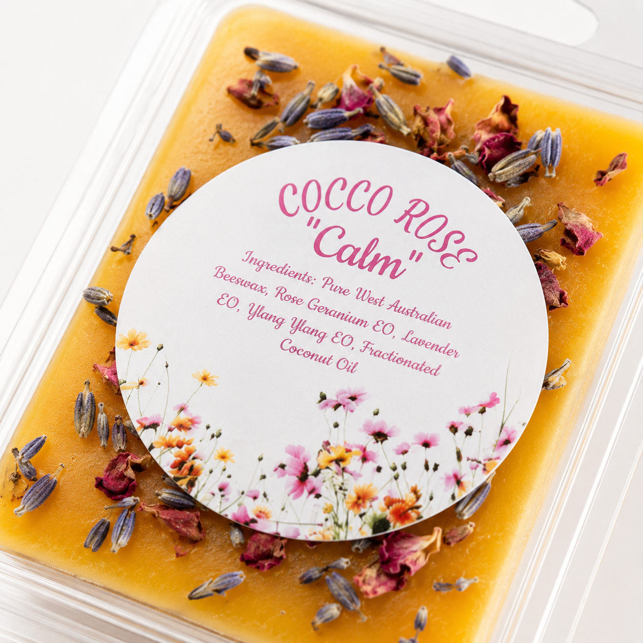 Clamshell wax melt sprinkled with rose petals and lavender on a white background - Cocco Rose Calm 