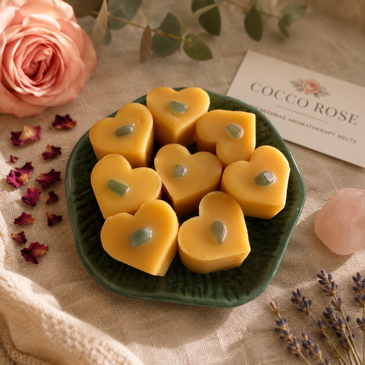 Love heart wax melts with green crystals on a decorative table with a rose, rose petals lavender, Cocco Rose card and a pink crystal - Cocco Rose